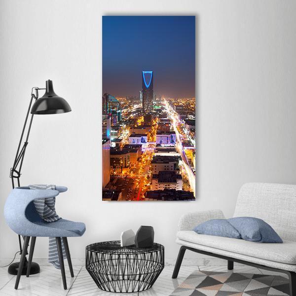 Riyadh Skyline at Night Vertical Canvas Wall Art in black, gold and blue, single vertical panel hung on a wall