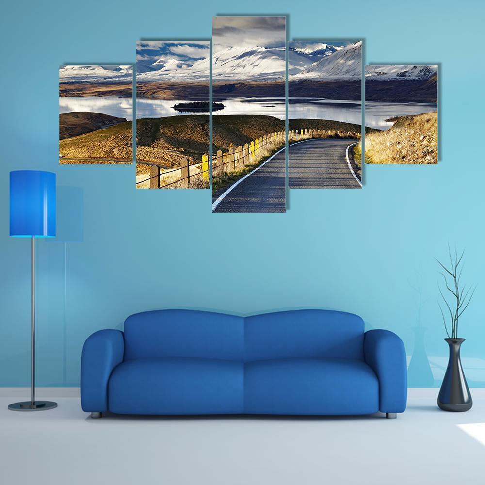 Winding Road Beside Snow-capped Mountain Lake Canvas Wall Art in white, gray and blue, 5 panel Star layout hung on a wall