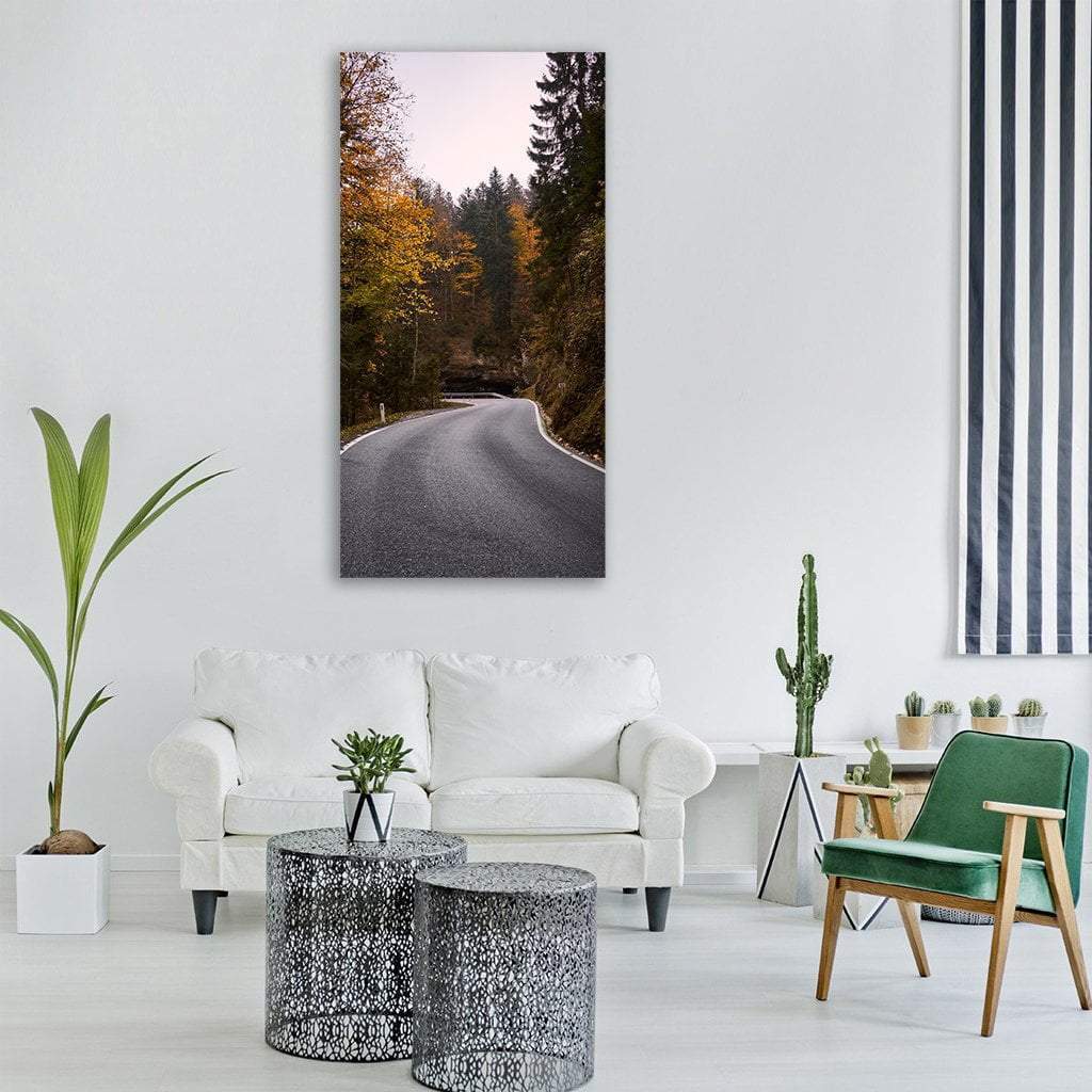 Autumn Forest Road Vertical Canvas Wall Art in gray, orange and green, single vertical panel hung on a wall