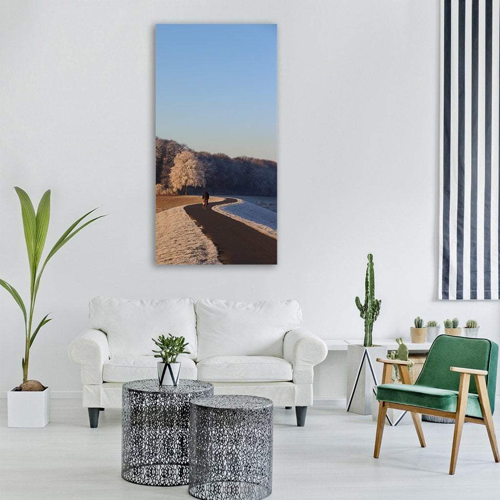 Lone Cyclist on Frosted Winter Path Vertical Canvas Wall Art in white, brown and blue, single vertical panel hung on a wall