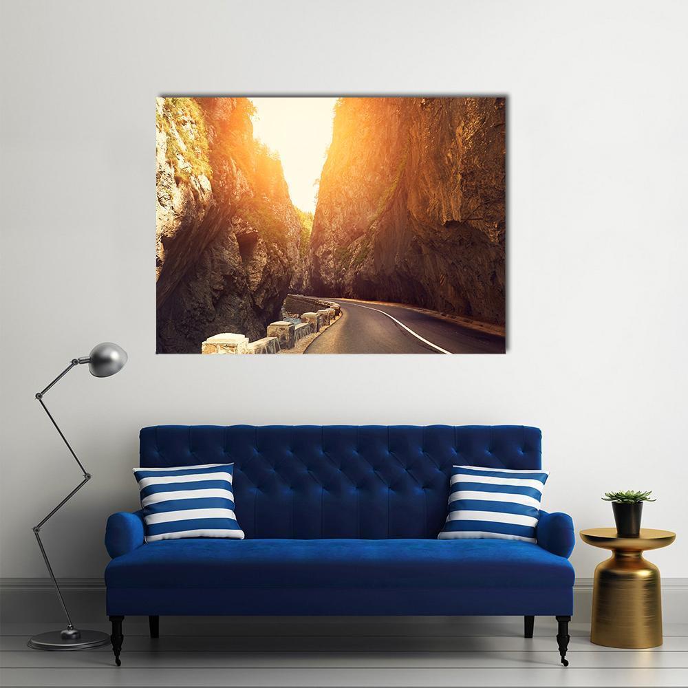 Mountain Road Through Sunlit Canyon Canvas Wall Art in brown, orange and yellow, single panel hung on a wall