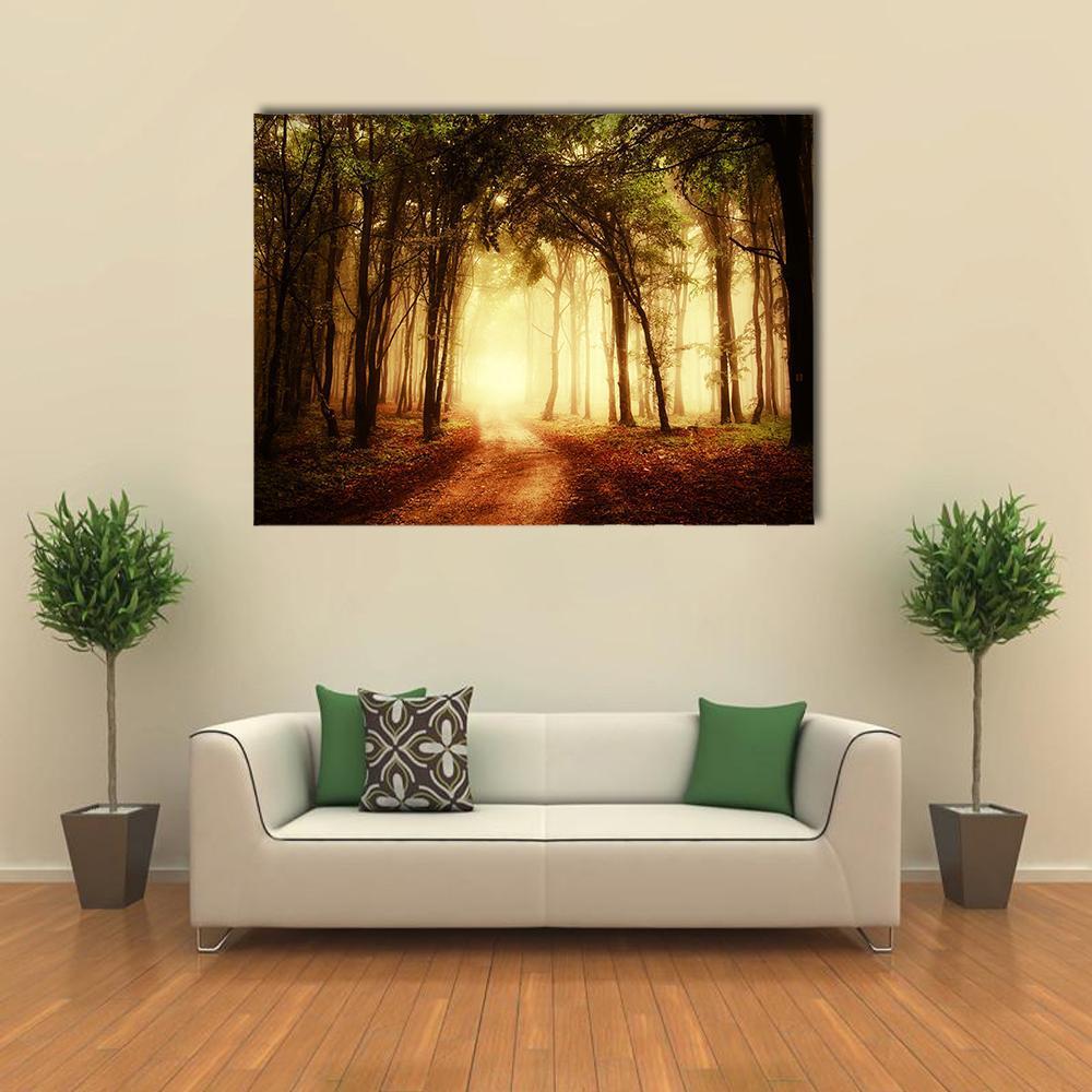 Golden Autumn Path Through a Peaceful Forest Canvas Wall Art in brown, gold and yellow, single panel hung on a wall