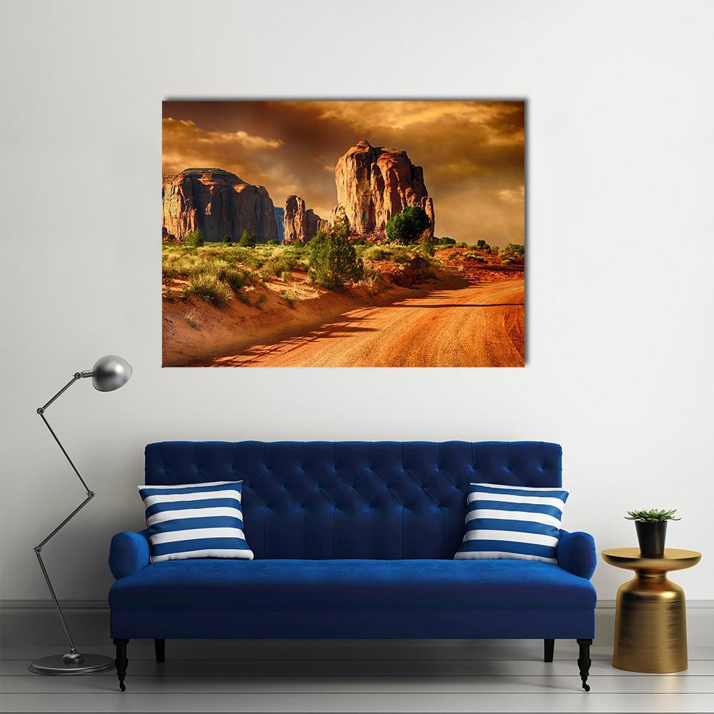 Road Through Monument Valley Canvas Wall Art in brown, orange and yellow, single panel hung on a wall
