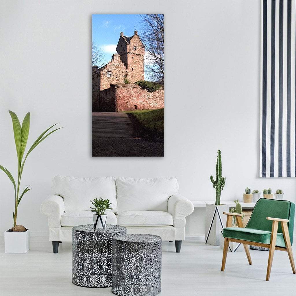 Cobblestone Path to Red Brick Castle Vertical Canvas Wall Art in brown, red and blue, single vertical panel hung on a wall