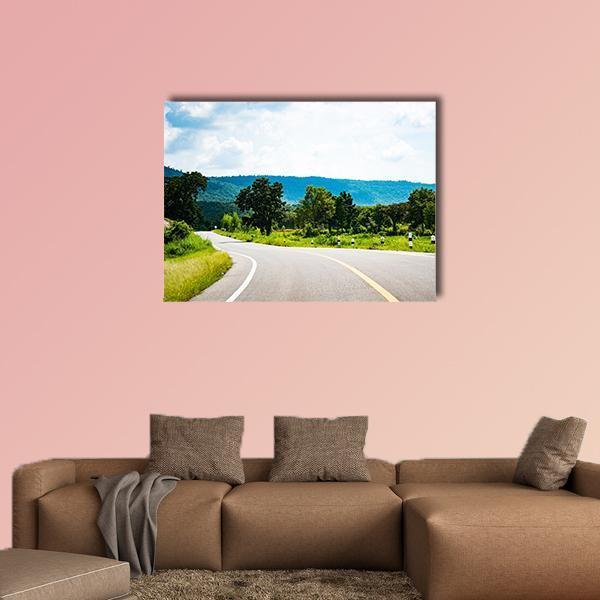 Country Road to Mountain Canvas Wall Art in gray, green and blue, single panel hung on a wall