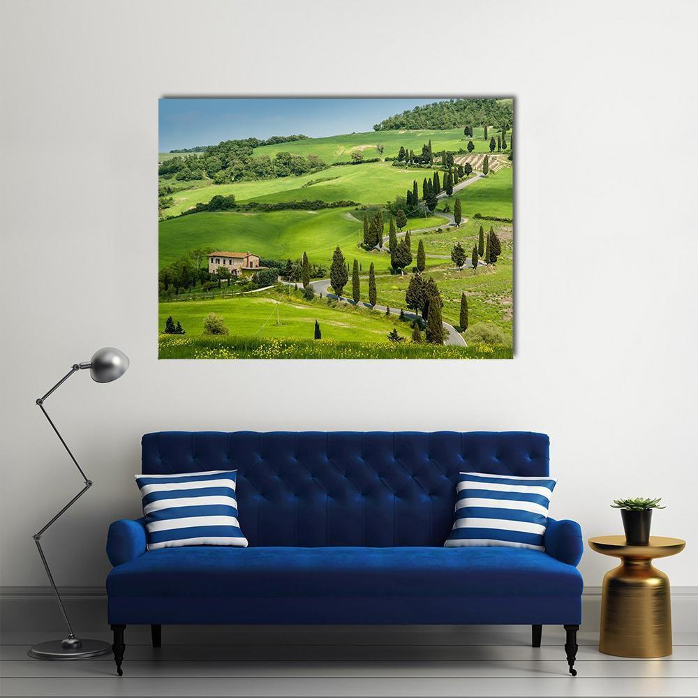 Winding Road with Cypress Trees Canvas Wall Art in green and blue, single panel hung on a wall
