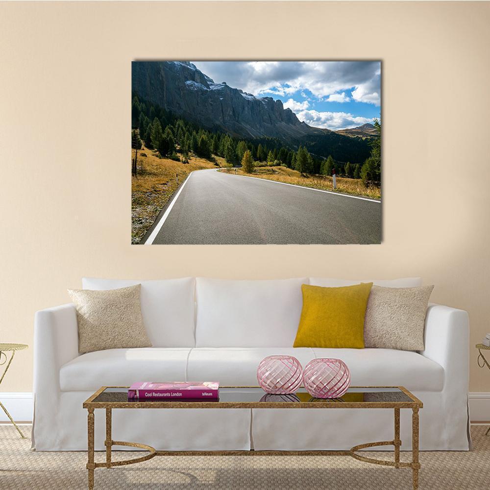 Winding Mountain Road Through Forest Canvas Wall Art in gray, green and blue, single panel hung on a wall