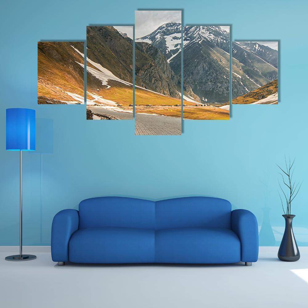 Cobblestone Mountain Road to Snow-capped Peaks Canvas Wall Art in white, gray and brown, 5 panel Star layout hung on a wall