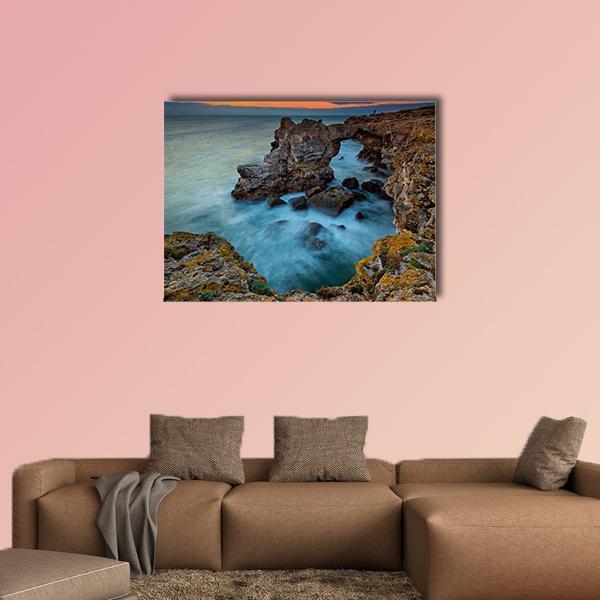 Coastal Rock Arch in Bulgaria Canvas Wall Art in brown, orange and blue, single panel hung on a wall