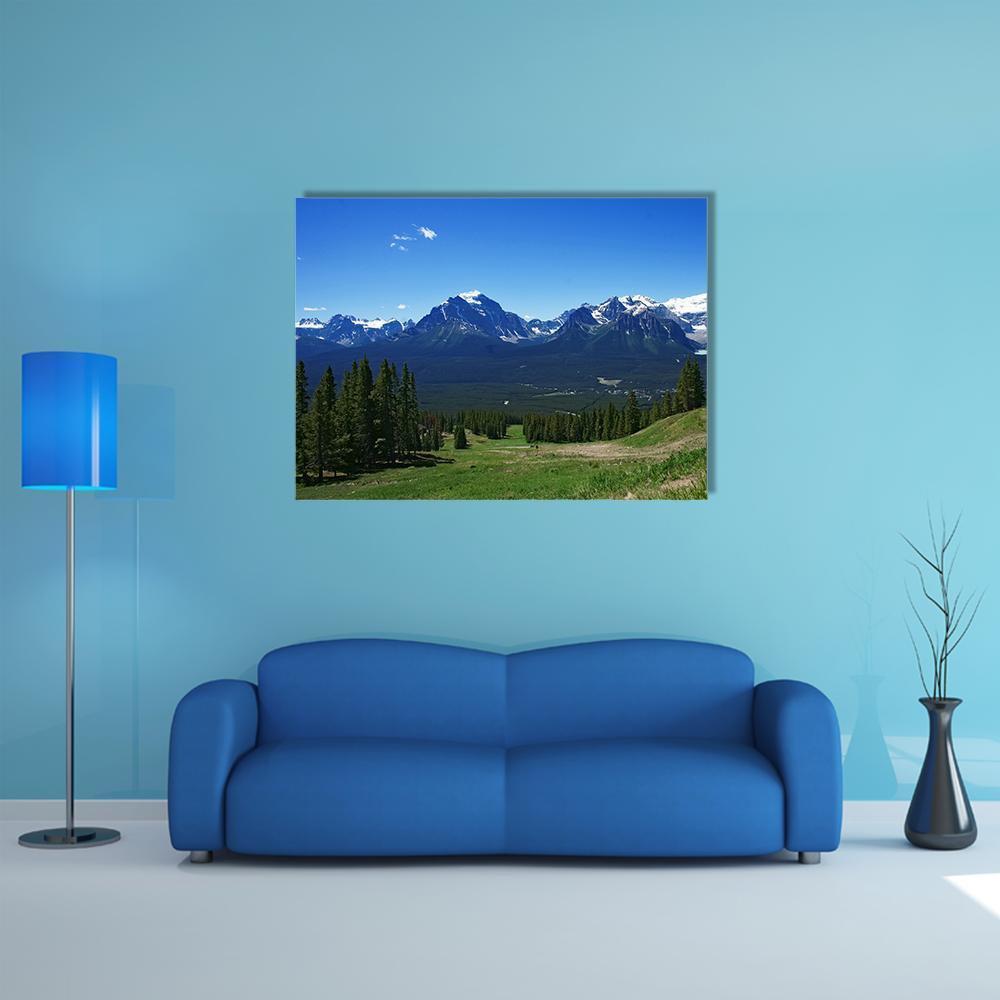 Banff Rockies with Snow-capped Peaks Canvas Wall Art in white, green and blue, single panel hung on a wall