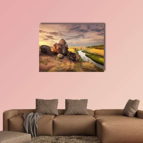Rocks and Winding River at Sunset Canvas Wall Art in brown, orange and yellow, single panel hung on a wall