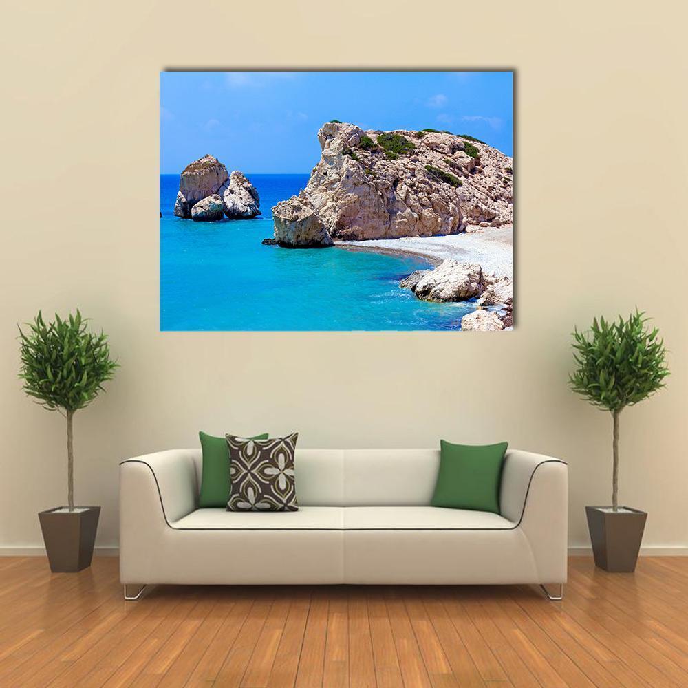Craggy Seaside Rocks and Turquoise Water Canvas Wall Art in beige, brown and blue, single panel hung on a wall