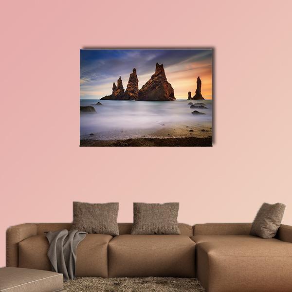 Black Beach Rocks in Iceland Canvas Wall Art in gray, brown and blue, single panel hung on a wall