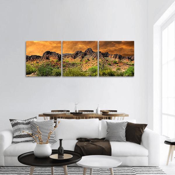 Saguaro and Desert Mountains at Sunset Panoramic Canvas Wall Art in brown, orange and green, hung on a wall