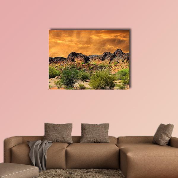 Rocky Mountains Sunset with Stormy Sky Canvas Wall Art in brown, orange and green, single panel hung on a wall