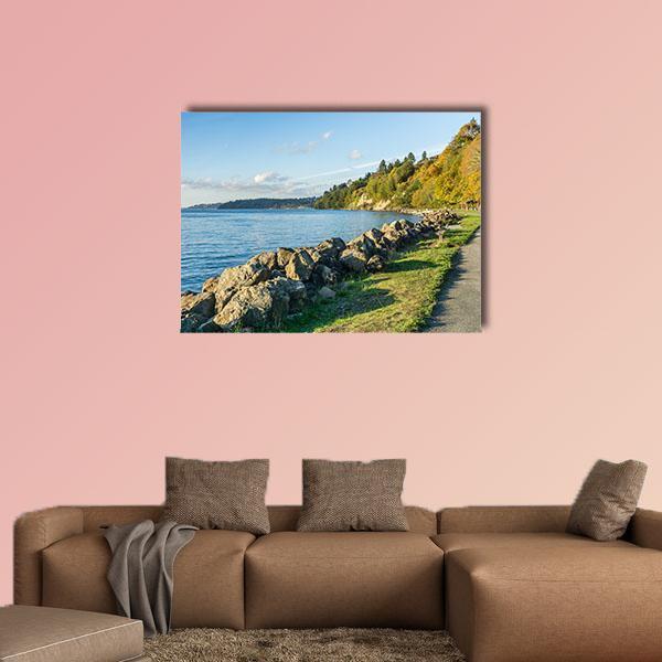 Autumn Rocky Shoreline with Pathway Canvas Wall Art in brown, green and blue, single panel hung on a wall