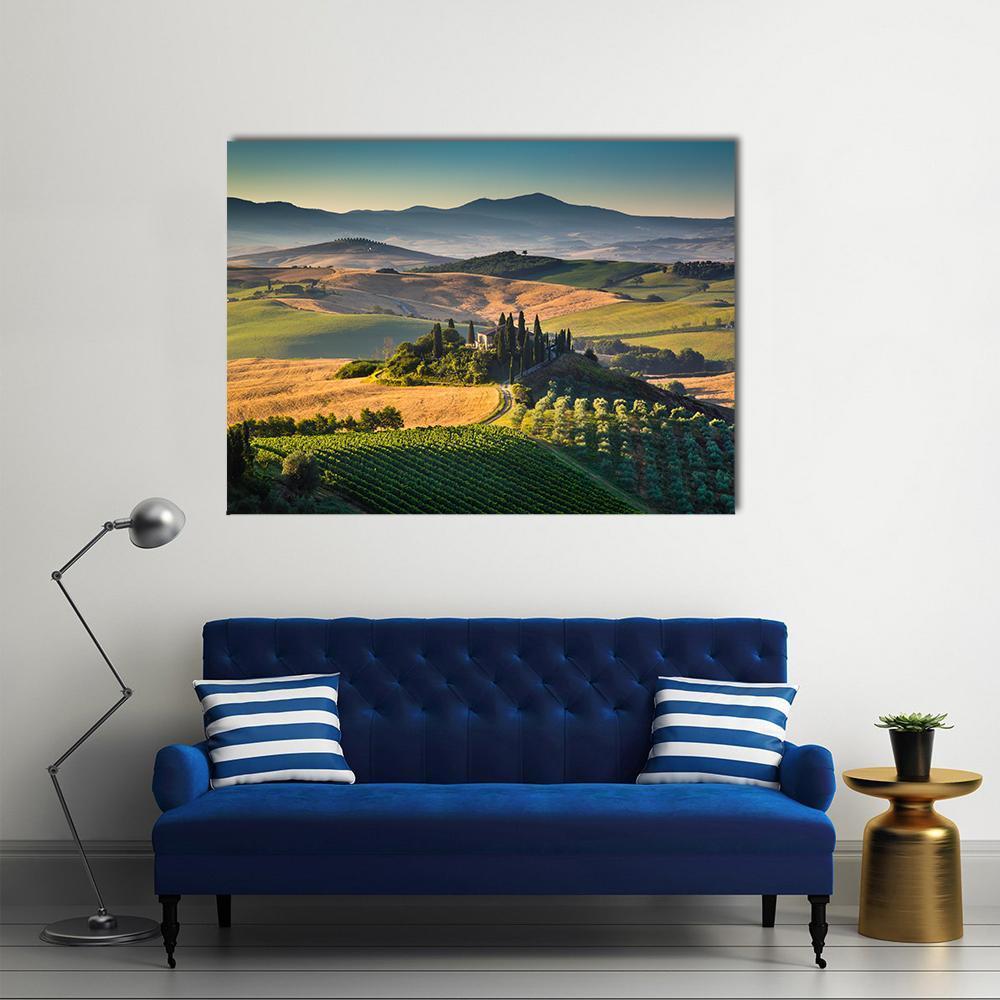 Tuscan Hills in Morning Light Canvas Wall Art in yellow, green and blue, single panel hung on a wall
