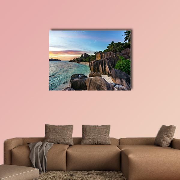 Romantic Sunset on Paradise Beach Canvas Wall Art in brown, orange and blue, single panel hung on a wall