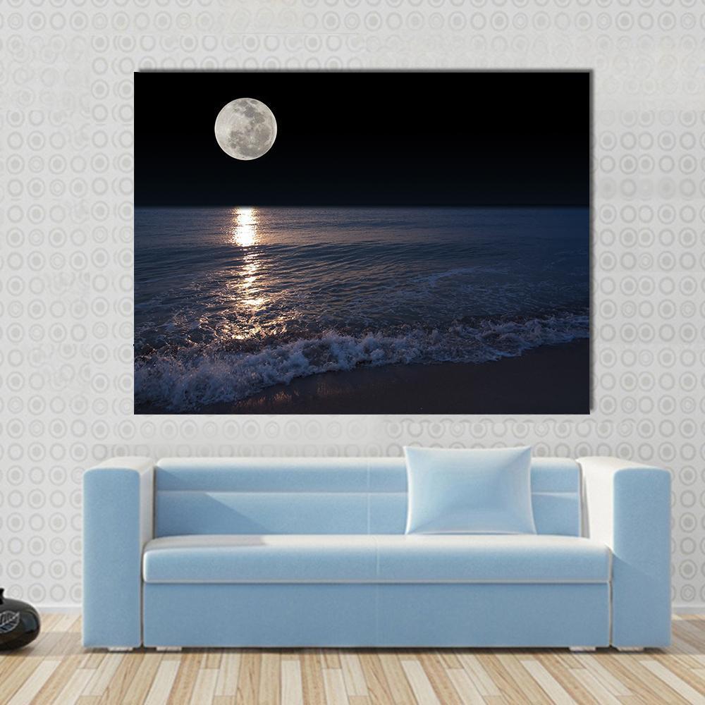 Full Moon Over Tropical Shoreline Canvas Wall Art in black and blue, single panel hung on a wall