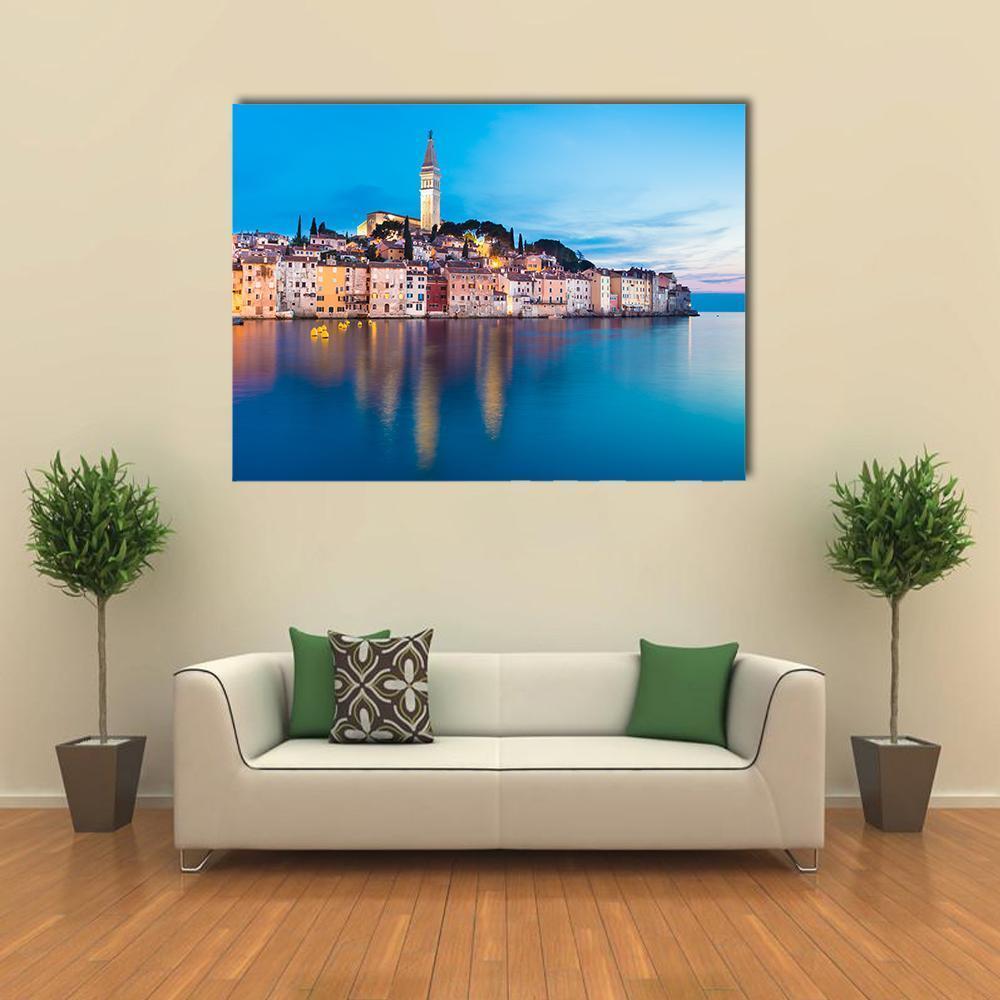 Rovinj Coastal Town at Dusk Canvas Wall Art in orange, yellow and blue, single panel hung on a wall
