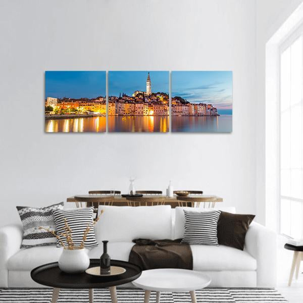 Rovinj Old Town Harbor at Blue Hour Panoramic Canvas Wall Art in orange, yellow and blue, hung on a wall