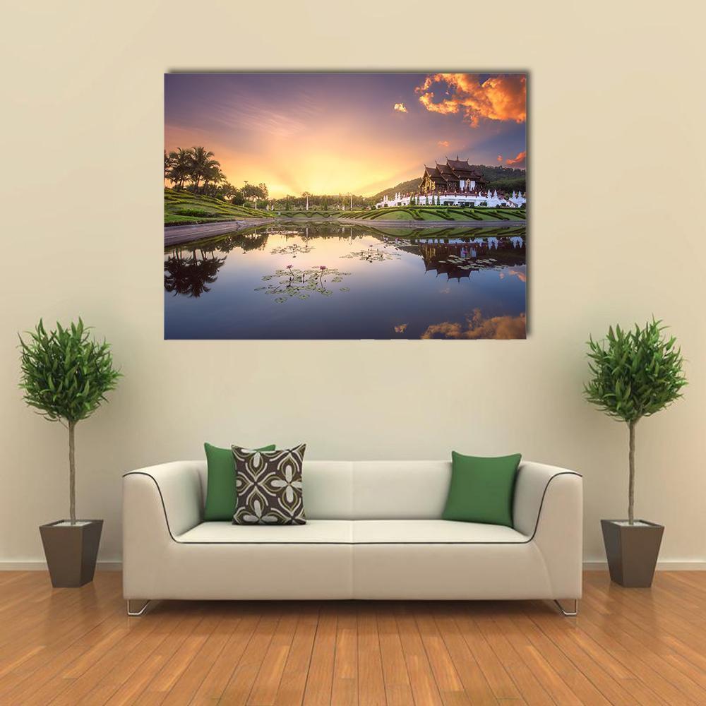 Lotus Lake with Temple at Sunset Canvas Wall Art in orange, yellow and blue, single panel hung on a wall