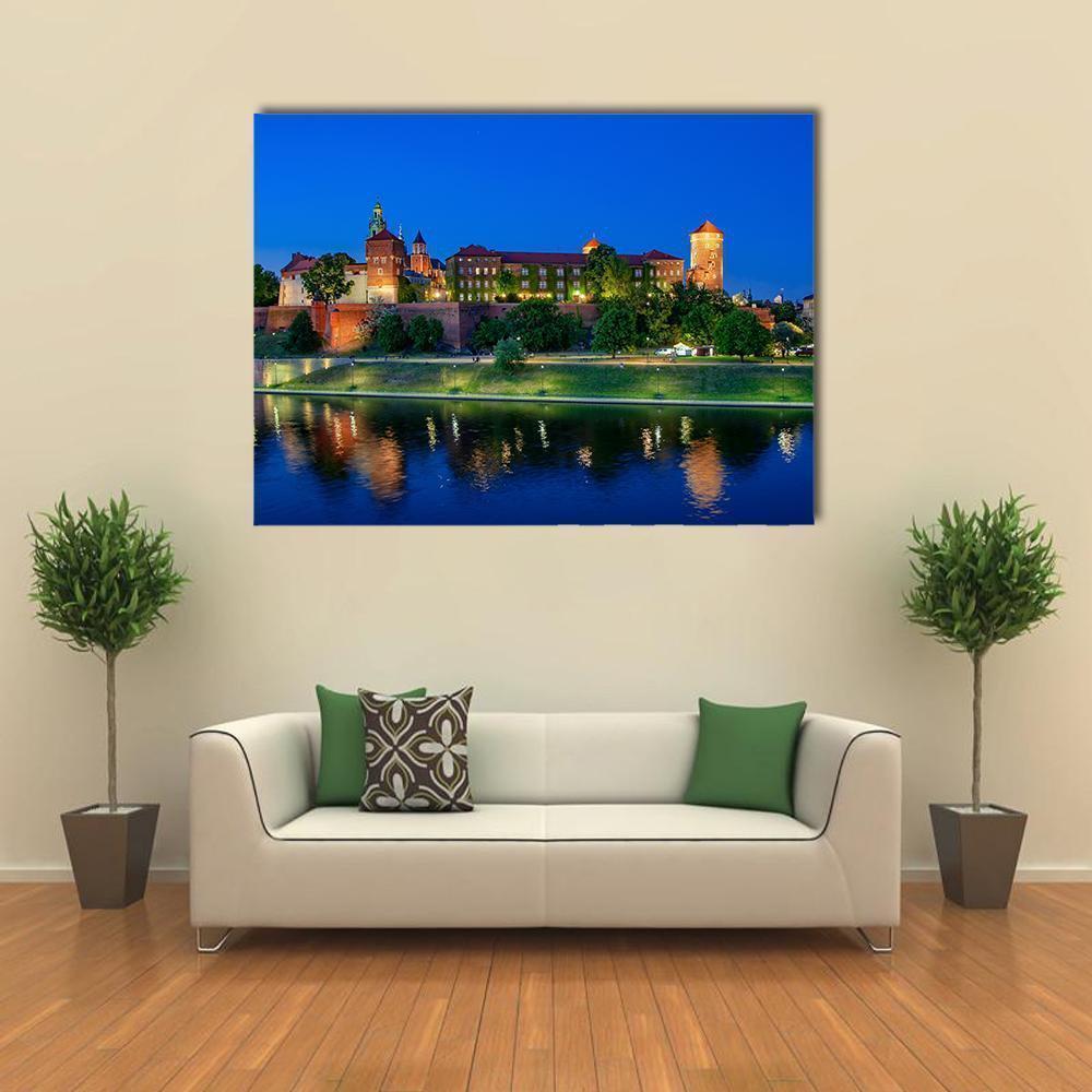 Wawel Royal Castle at Night Over Vistula Canvas Wall Art in orange, green and blue, single panel hung on a wall