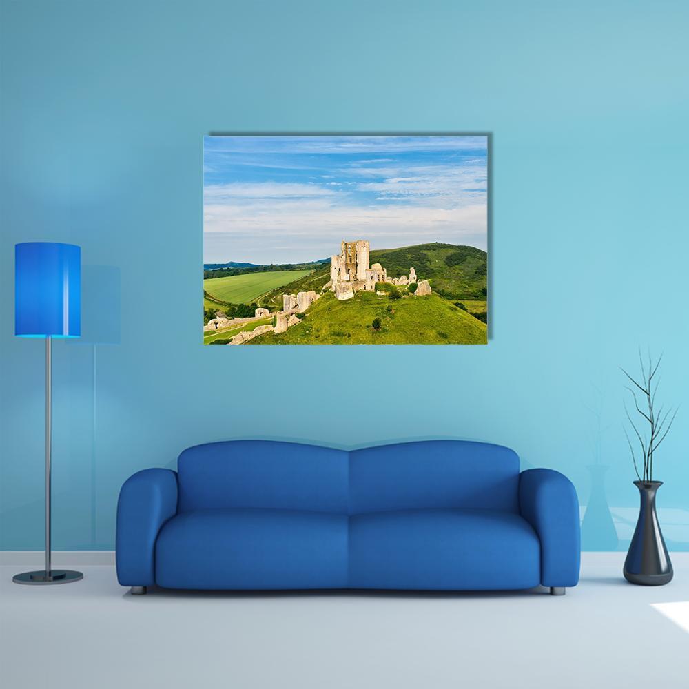 Ruins of Corfe Castle Canvas Wall Art in beige, green and blue, single panel hung on a wall