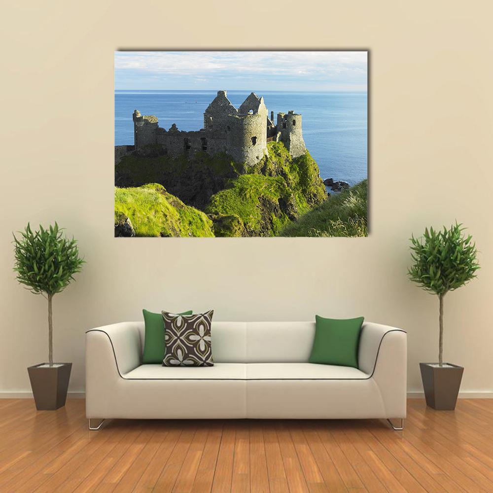 Dunluce Castle Ruins Canvas Wall Art in gray, green and blue, single panel hung on a wall