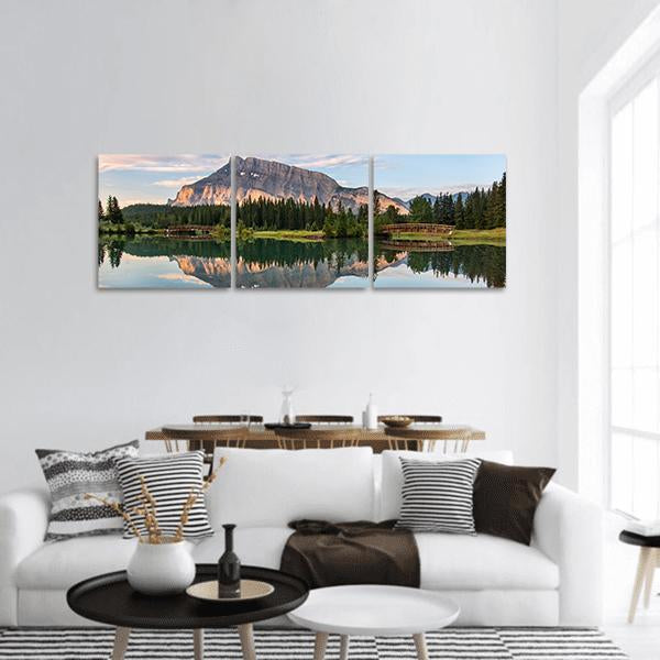 Rundle Mountain Reflection in Banff Park Panoramic Canvas Wall Art in gray, green and blue, hung on a wall