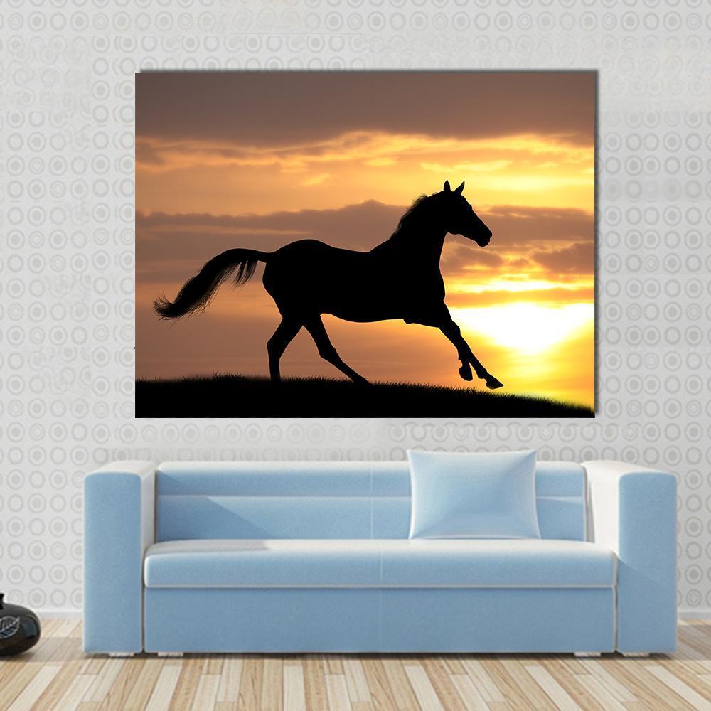 Running Horse Silhouette Canvas Wall Art in black, orange and yellow, single panel hung on a wall
