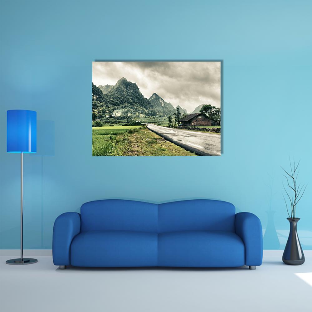 Rain-soaked Mountain Road with Rural House Canvas Wall Art in gray, brown and green, single panel hung on a wall