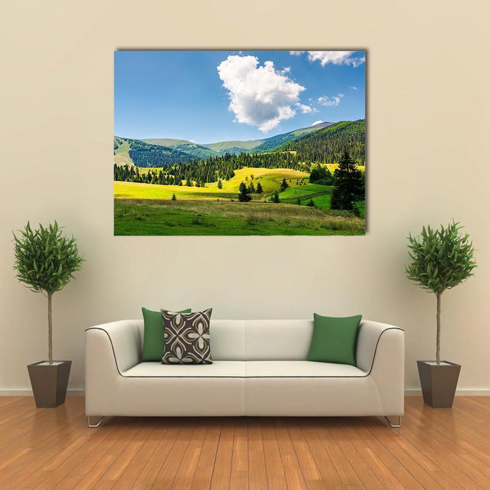 Rural Mountain Landscape with Lush Fields Canvas Wall Art in yellow, green and blue, single panel hung on a wall