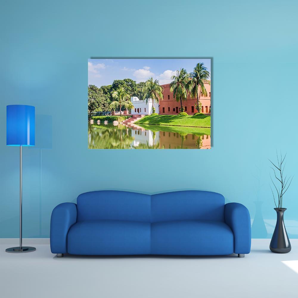 Sadarbari Rajbari Palace with Water Reflection Canvas Wall Art in orange, green and blue, single panel hung on a wall