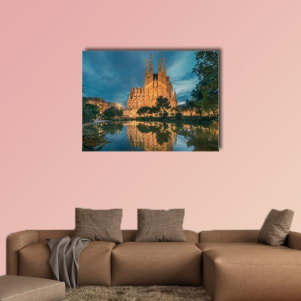 Sagrada Família Reflection at Twilight Canvas Wall Art in gold, orange and blue, single panel hung on a wall