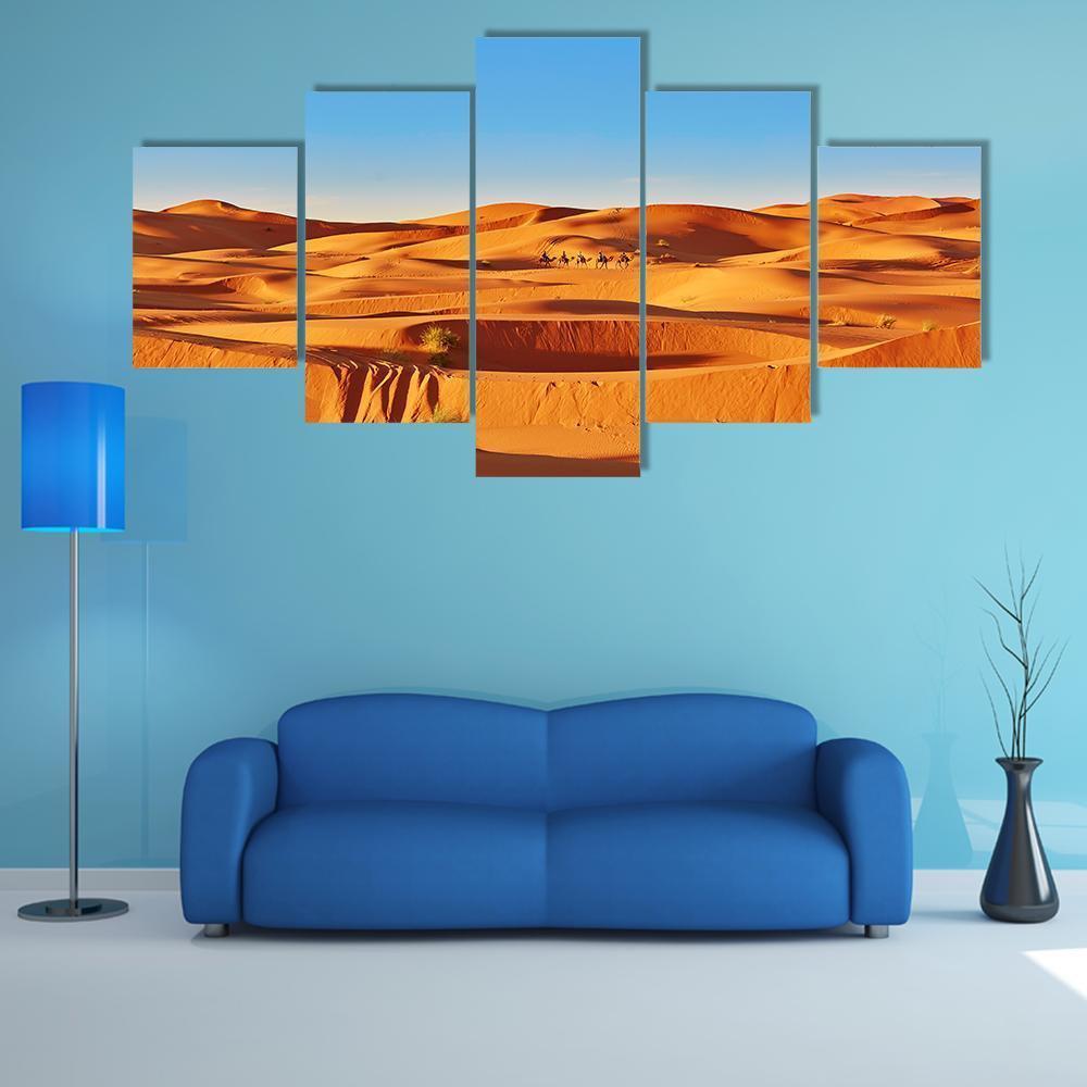 Sahara Dunes with Camel Caravan Canvas Wall Art in beige, orange and blue, 5 panel Star layout hung on a wall