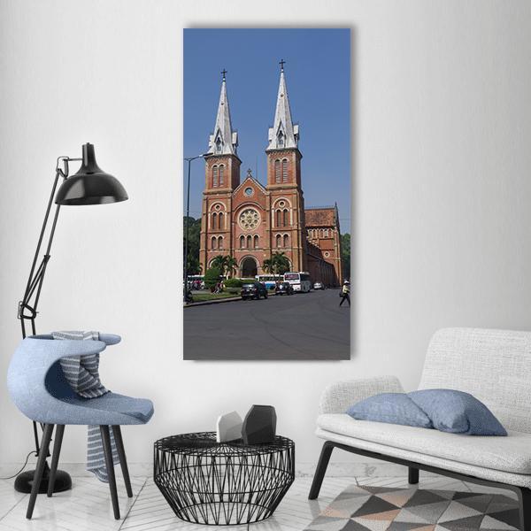 Saigon Notre-dame Cathedral Vertical Canvas Wall Art in brown, red and blue, single vertical panel hung on a wall