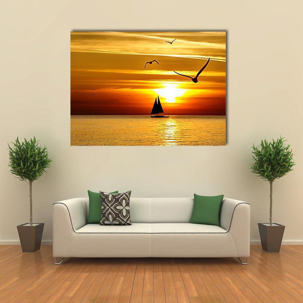 Sailboat at Sunset Canvas Wall Art in gold, orange and yellow, single panel hung on a wall