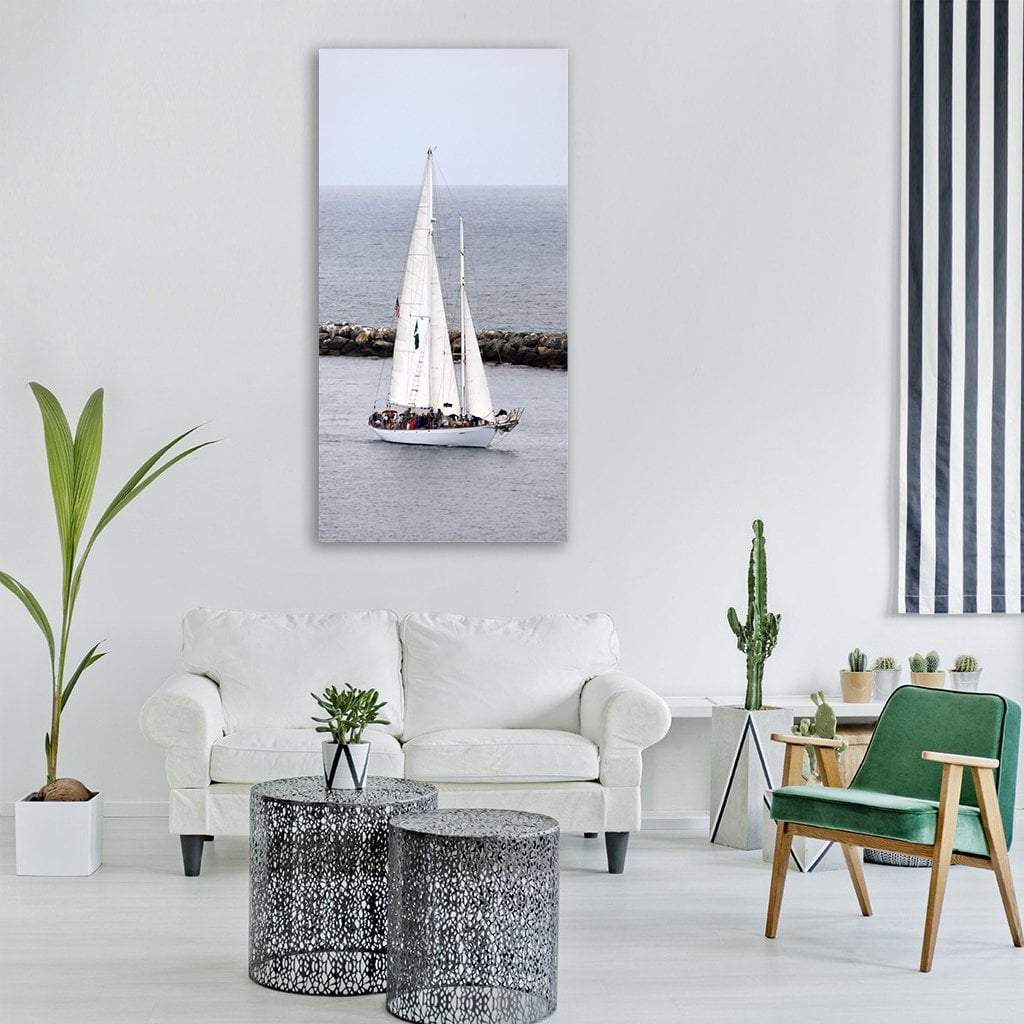 Two-masted Sailboat with Stone Breakwater Vertical Canvas Wall Art in white, gray and blue, single vertical panel hung on a wall