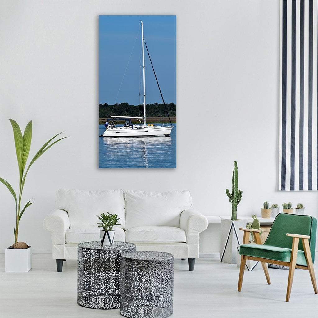 Sailboat on Calm Blue Water Vertical Canvas Wall Art in white and blue, single vertical panel hung on a wall