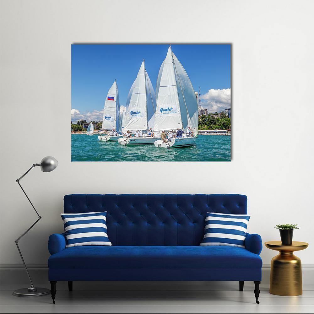 Three Sailboats in a Regatta Canvas Wall Art in white and blue, single panel hung on a wall