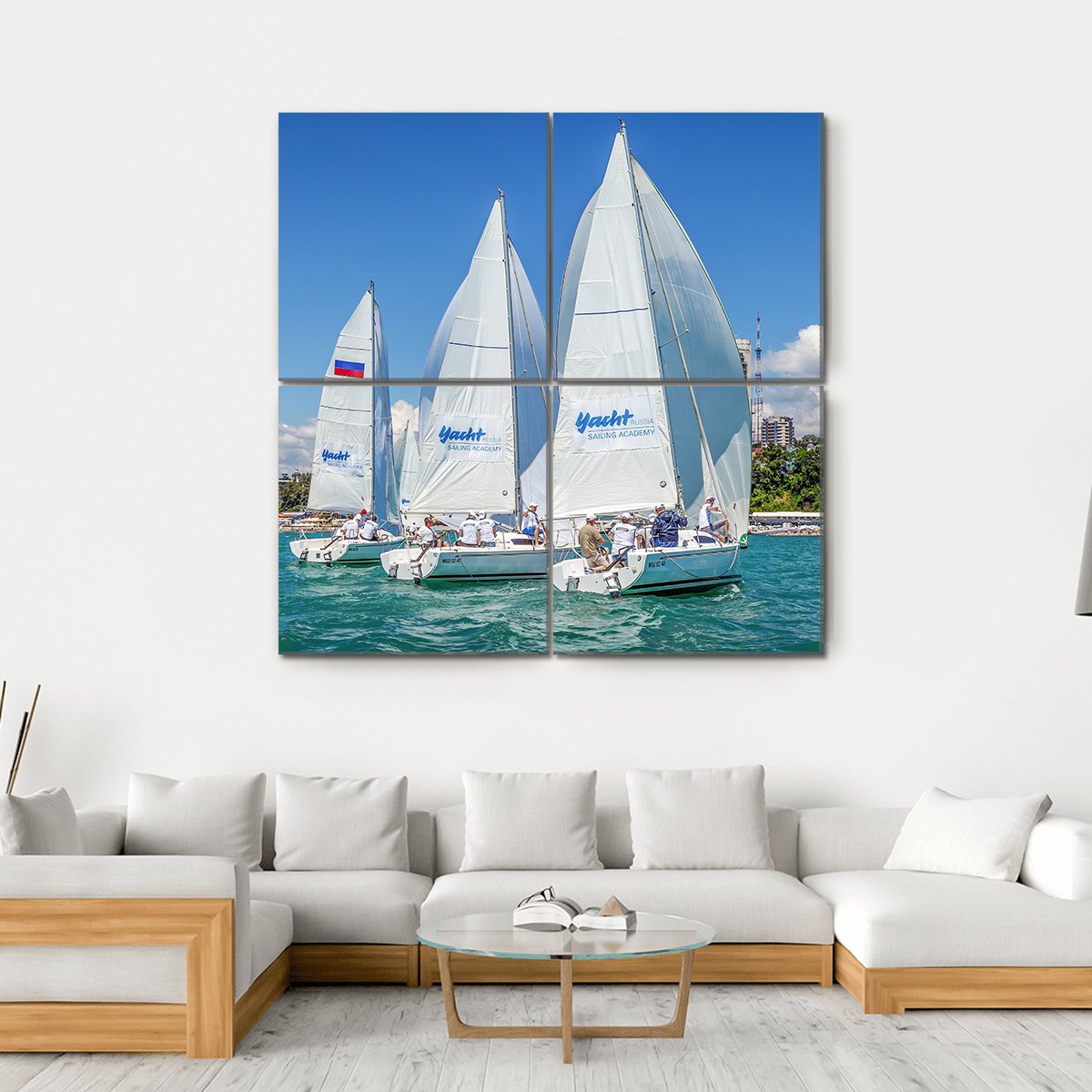 Three Sailboats in a Regatta Canvas Wall Art in white and blue, hung on a wall