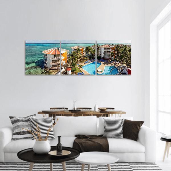 San Andres Island Resort Poolside View Panoramic Canvas Wall Art in orange, green and blue, hung on a wall