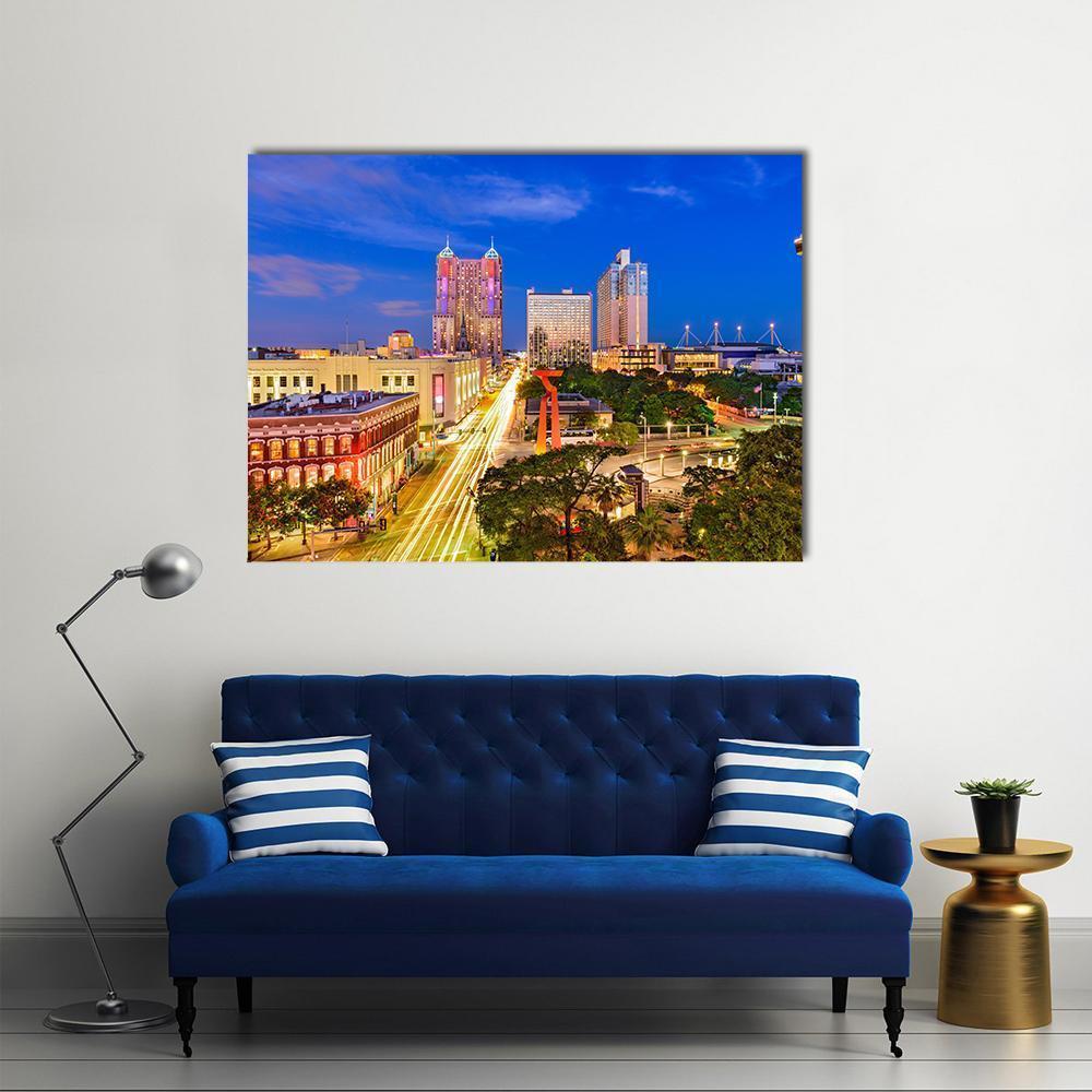 San Antonio Light Trails at Twilight Canvas Wall Art in orange, yellow and blue, single panel hung on a wall