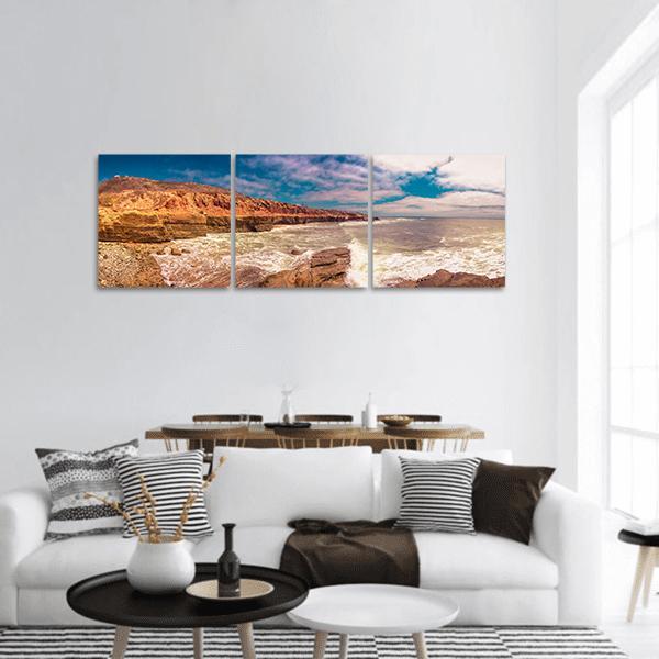 San Diego Coastal Cliffs with Crashing Ocean Waves Panoramic Canvas Wall Art in beige, brown and blue, hung on a wall
