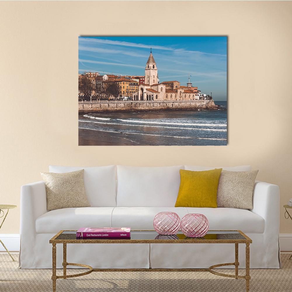 Seaside Church Beside Sandy Beach Canvas Wall Art in beige, brown and blue, single panel hung on a wall