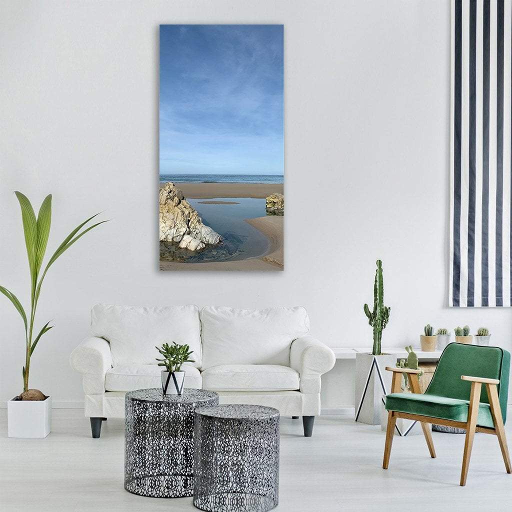Summer Tidal Pool Beach with Light Rock Formation Vertical Canvas Wall Art in beige, brown and blue, single vertical panel hung on a wall