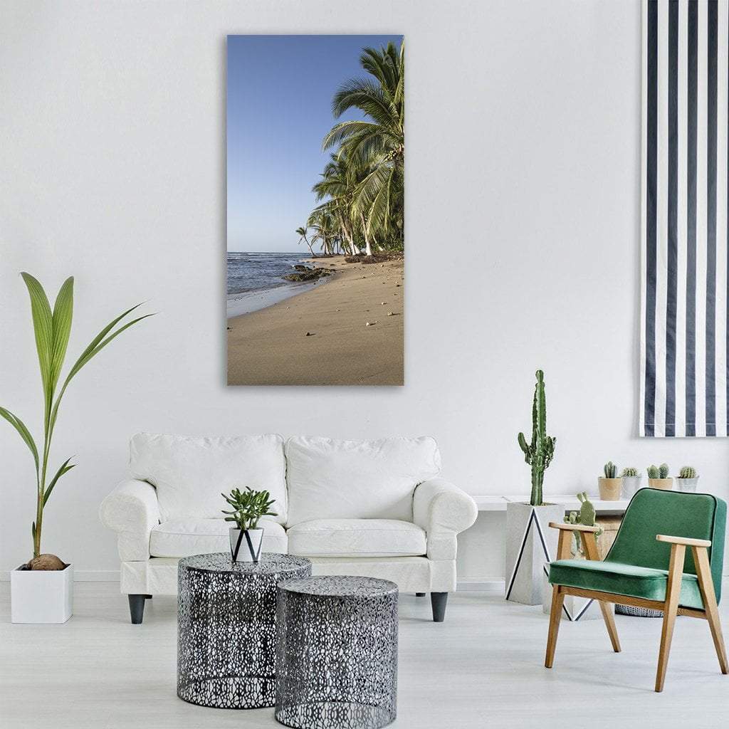 Tropical Beach with Palm Trees and Waves Vertical Canvas Wall Art in brown, green and blue, single vertical panel hung on a wall