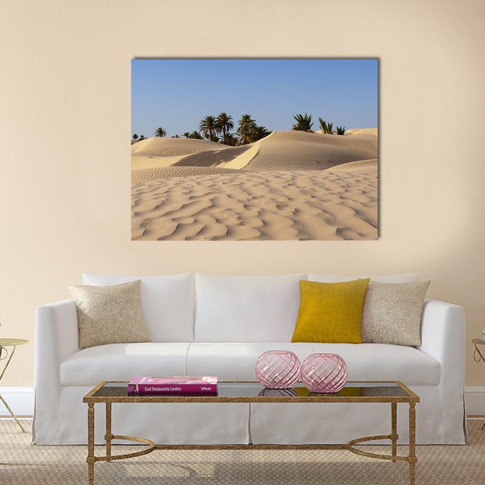 Desert Dunes and Palm Trees Canvas Wall Art in beige and blue, single panel hung on a wall