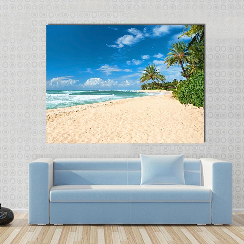 Sandy Beach with Palm Trees and Azure Ocean Canvas Wall Art in beige, green and blue, single panel hung on a wall